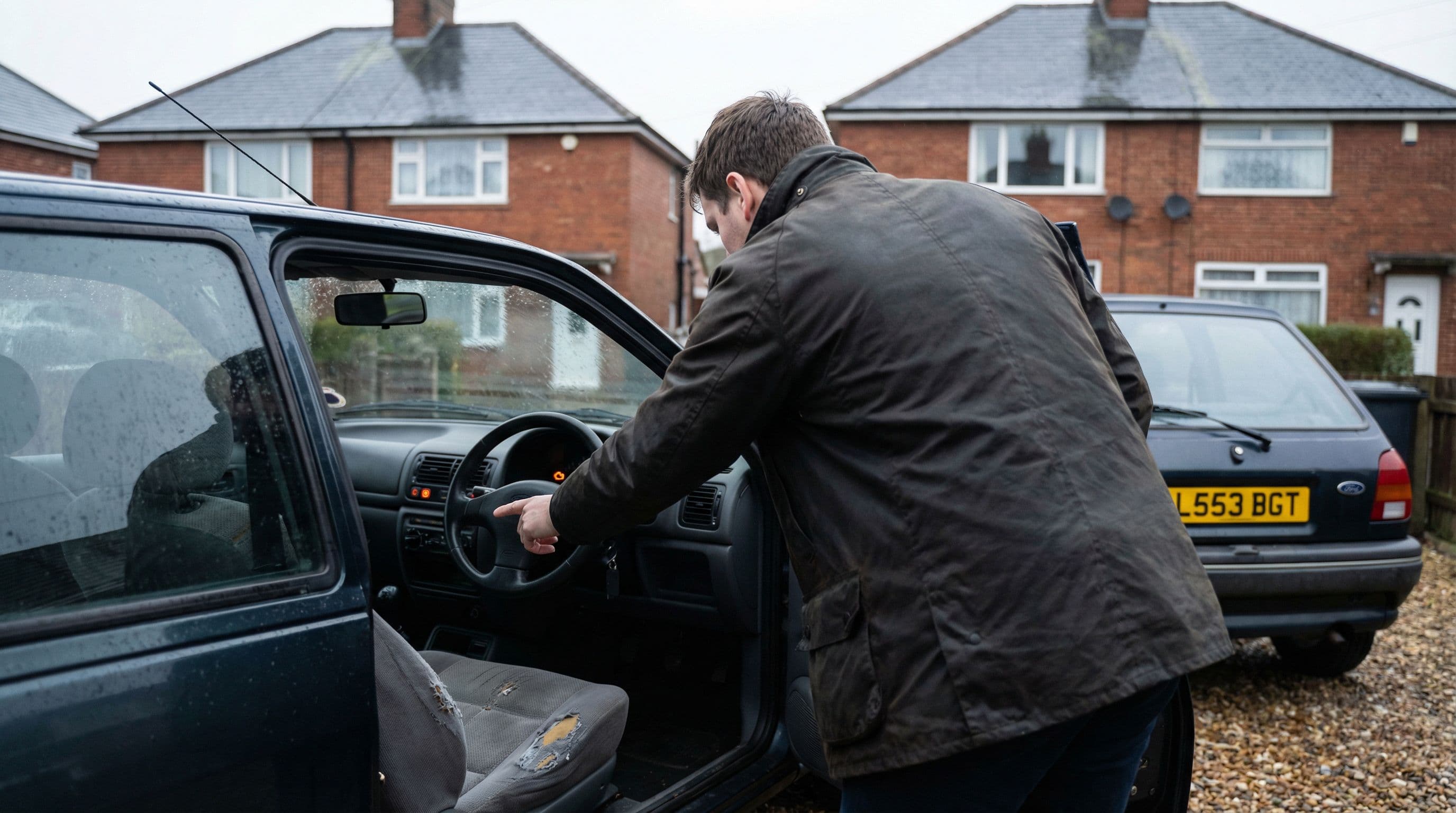 A buyer examines dashboard warning lights and interior condition during vehicle inspection
