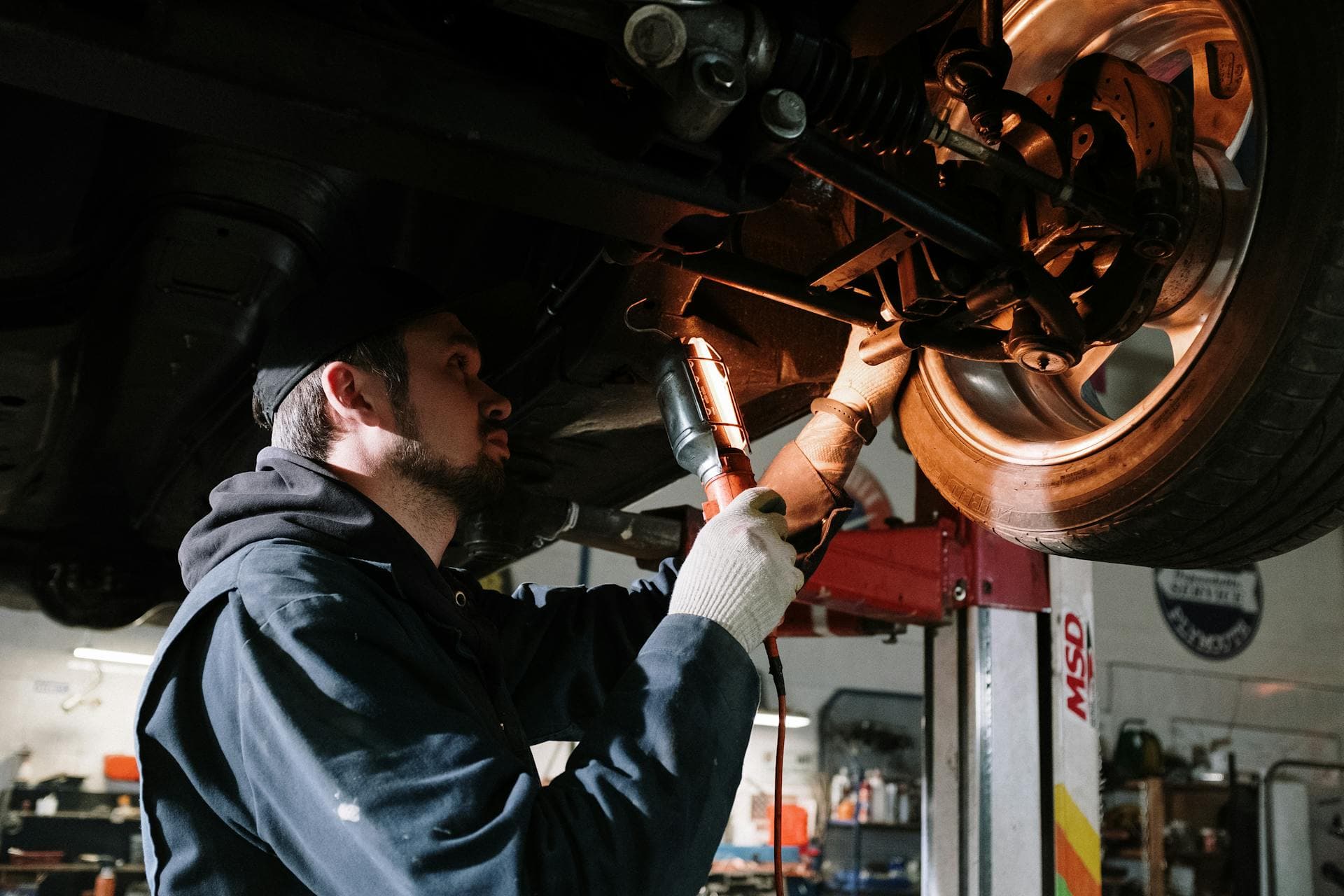 Mechanic inspecting under car