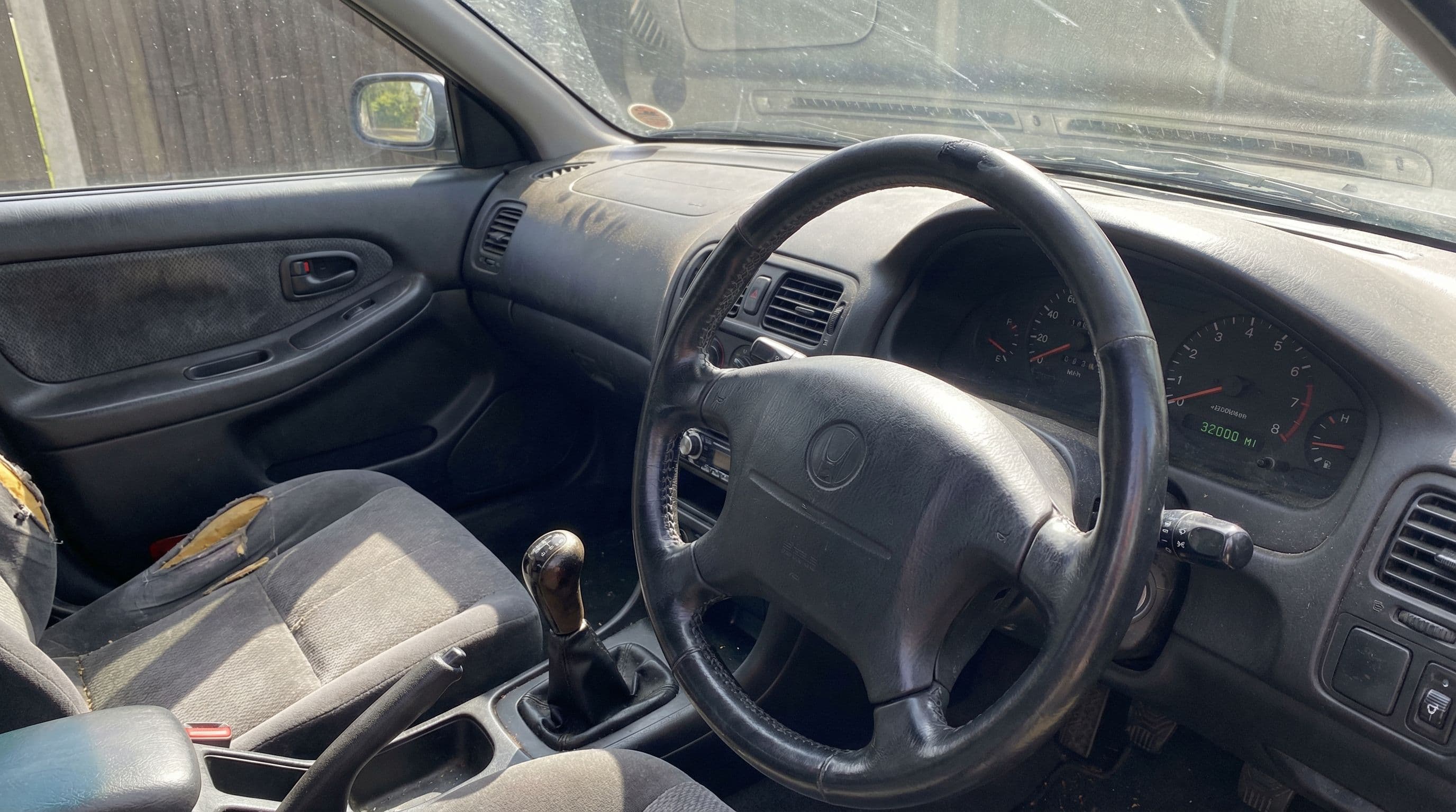 Suspiciously low odometer reading in a car with a visibly worn steering wheel and seats