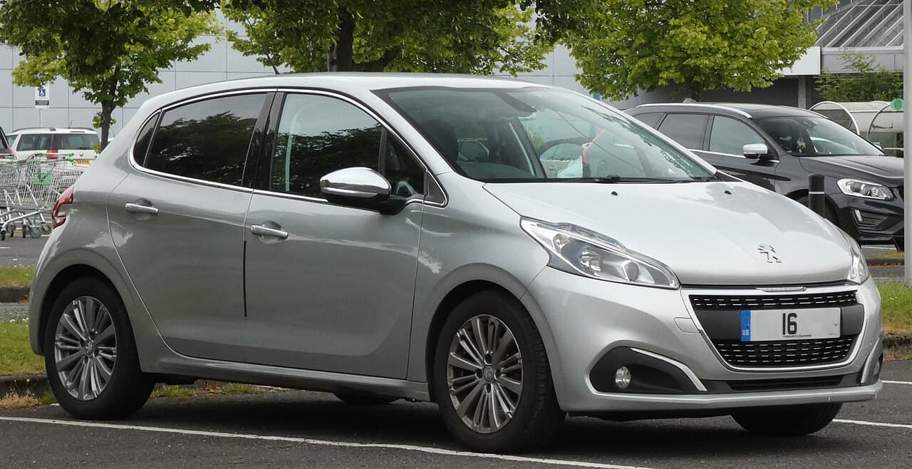 A silver 2016 Peugeot 208 with the 1.2 PureTech petrol engine, parked in a UK car park